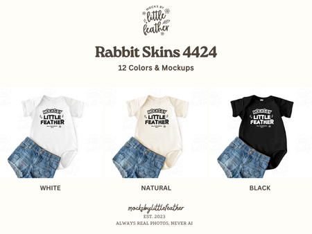 a collection of baby clothing items, including a white onesie, a natural onesie, and a black onesie, along with a pair of denim shorts.