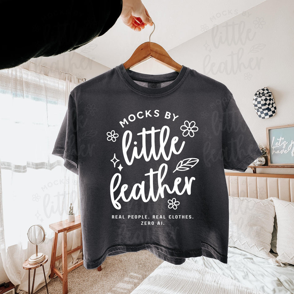 Boxy crop tee mockup, dark gray with centered “little leather” front graphic.